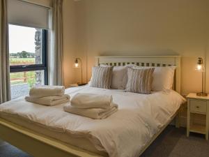 a bedroom with a bed with white sheets and pillows at Church View - Ukc5700 in Castletown