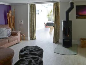 a living room with a wood burning stove in it at Riverside in Bude