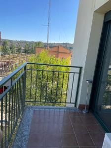 a balcony with a black railing and a view at Acogedor apartamento Vallparadís con parking in Terrassa