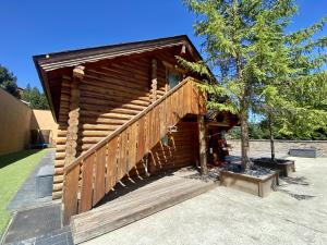 a log cabin with a wooden staircase next to a tree at Appartement Les Angles, 4 pièces, 6 personnes - FR-1-758-11 in Les Angles