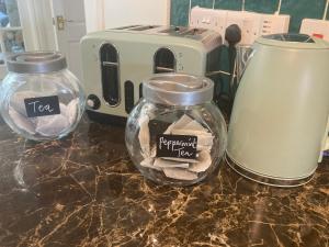 a counter with two glass jars and a toaster at The Stay @ 155 
