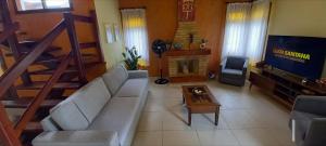 a living room with a couch and a fireplace at Morada BEACHE HOUSE 515 in Bertioga