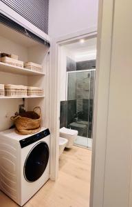 a washing machine in a bathroom with a toilet at Apartment Suite - Charlize - in the heart of Milan in Milan