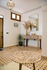 um quarto com um espelho e uma mesa com um espelho em Riad Sabria em Marrakech