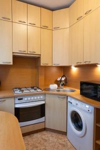 a kitchen with a stove and a washing machine at ClickTheFlat Krucza City Center Apart Rooms in Warsaw