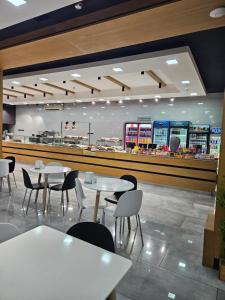 a restaurant with tables and chairs and a counter at Galstyans HOTEL EVN Airport in Yerevan