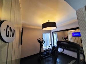 ein Zimmer mit einem Fitnessraum mit einem Laufband und einer Lampe in der Unterkunft Hotel Plaza Revolución in Mexiko-Stadt