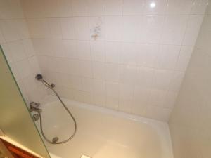 a bathroom with a shower and a white tub at Studio Tignes, 1 pièce, 4 personnes - FR-1-502-504 in Tignes