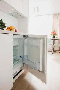 an open refrigerator in a kitchen with fruit in it at Apartment in Žvėrynas in Vilnius