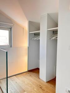 an empty room with white walls and a window at La Loggia dei Mercanti in Cuneo +20 photos