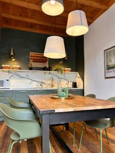 a kitchen with a wooden table and chairs at La Loggia dei Mercanti in Cuneo