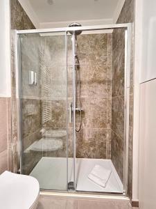 a shower with a glass door in a bathroom at La Loggia dei Mercanti in Cuneo