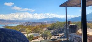 a view of snow covered mountains from a house at La Calma Ecolodge in Las Heras