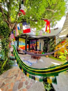 a hammock in front of a house at Hostal Casa Tropicalia in Barranquilla +36 photos