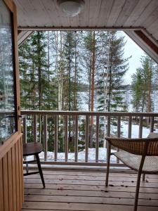 a porch with a hammock and a view of the woods at Jamali Cabin in Lieksa