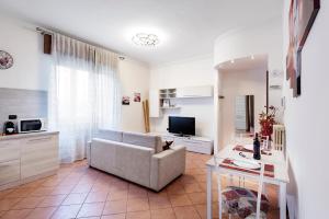 ein Wohnzimmer mit einem Sofa und einem TV in der Unterkunft Casa Viotti Monza in Monza