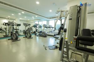 a gym with several treadmills and exercise bikes at 2 BR Perfect for Family/Groups near MOE in Dubai