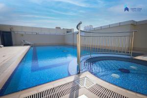 a swimming pool on the roof of a building at 2 BR Perfect for Family/Groups near MOE in Dubai