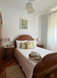 a bedroom with a large bed with two night stands at VILA GUIA in Valdreu in Braga