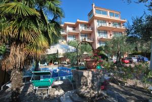 un hotel con piscina di fronte a un edificio di Residence Wieland a Torri del Benaco