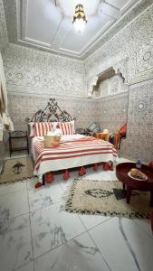 1 dormitorio con 1 cama en una habitación con papel pintado en Riad Hayat, en Marrakech