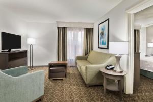 um quarto de hotel com um sofá e uma cama em Homewood Suites by Hilton Baton Rouge em Baton Rouge