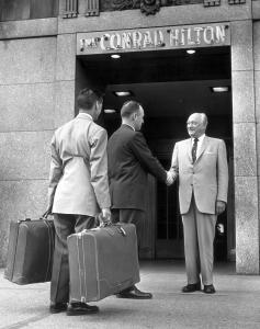 two men shaking hands in front of a building at Hilton Chicago in Chicago