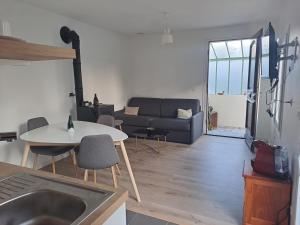 uma sala de estar com um sofá e uma mesa em Maisonnette em Corbeil-Essonnes