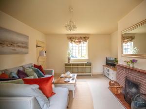 a living room with a couch and a fireplace at Dulcie Cottage in Benson