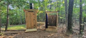 a wooden out house in the middle of a forest at Private place for rest in the forest Tent 1 Forrest Cump in Lenoir