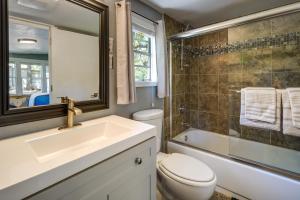 a bathroom with a sink and a toilet and a mirror at Waterfront Lake LBJ Cabin with Private Dock! in Burnet +23 photos