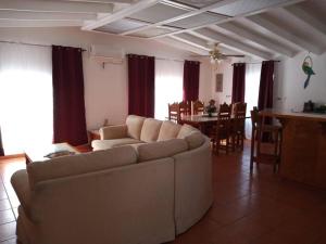 a living room with a couch and a dining room at Rosarito #12 beach front in Rosarito