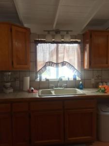 a kitchen with a sink and a window at Rosarito #12 beach front in Rosarito