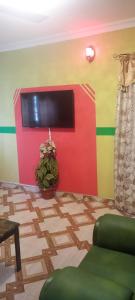 a room with a colorful wall with a tv at Executive Lodge in Kasoa