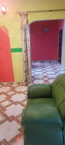 a living room with a couch and a colorful wall at Executive Lodge in Kasoa