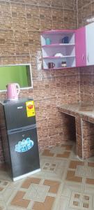 a room with a refrigerator and a table and boxes at Executive Lodge in Kasoa