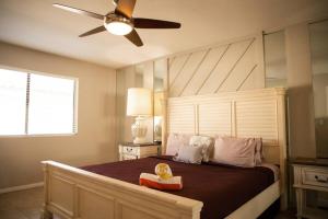 a bedroom with a large bed with a ceiling fan at Rancho Mirage Palm Springs Resort-Golf Tennis Pool in Rancho Mirage