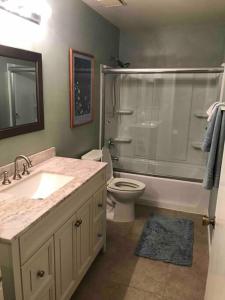 a bathroom with a shower and a toilet and a sink at Rancho Mirage Palm Springs Resort-Golf Tennis Pool in Rancho Mirage +20 photos