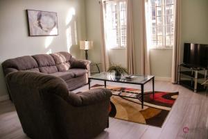 a living room with a couch and a coffee table at Hampton Apartments Guyana in Georgetown