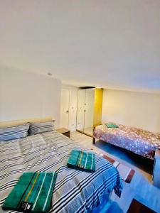 - une chambre avec 2 lits et des serviettes vertes dans l'établissement One Bed Room Flat Near Wembley stadium, à Londres