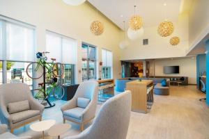 a living room with chairs and a bike on a rack at Element Sacramento Airport in Sacramento