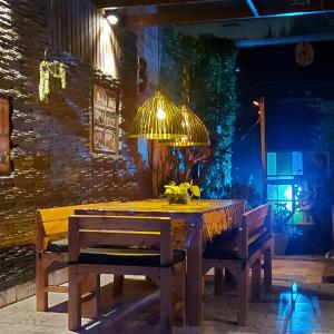 a wooden table with chairs and a light fixture at La Glicina casa in La Plata