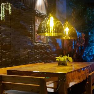 a wooden table with two lights above it at La Glicina casa in La Plata +26 photos