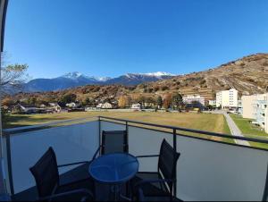 a balcony with chairs and a view of the mountains at Jacqueline residence in Sion