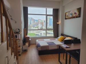 a hotel room with a bed and a large window at Travel House in Seoul