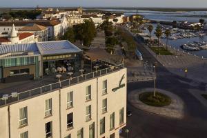 an aerial view of a city with a building at Occidental Faro in Faro