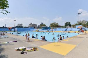 a group of people in a pool at a water park at Tuk Ahoy - Emerald Suite 3C with Shared Spaces in Brooklyn