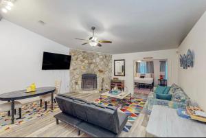 a living room with a couch and a fireplace at Peace On The Beach House in Panama City Beach