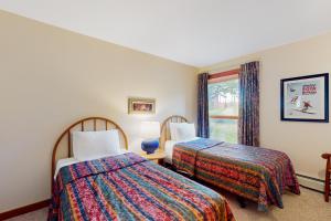 a hotel room with two beds and a window at Trail Creek 75 in Killington +49 photos