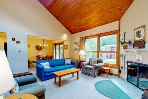 a living room with a blue couch and a fireplace at Trail Creek 42 in Killington